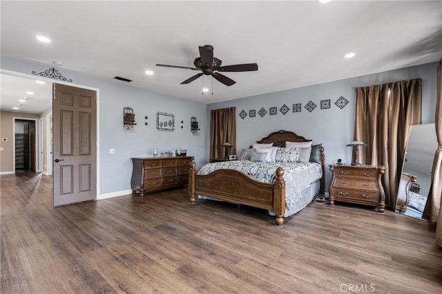 bedroom featuring baseboards, recessed lighting, wood finished floors, and visible vents