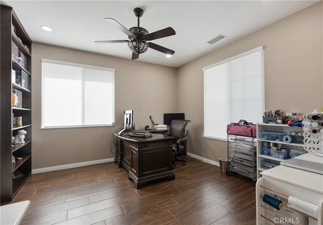 home office featuring baseboards, a ceiling fan, dark wood-style flooring, and visible vents