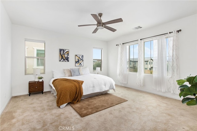 bedroom with visible vents, a ceiling fan, carpet, and baseboards