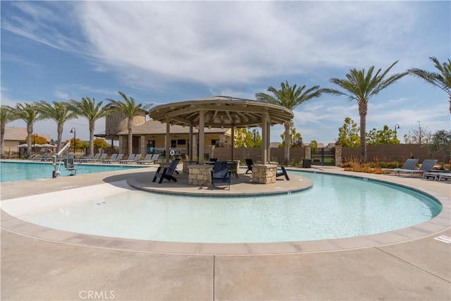 community pool featuring a patio and fence