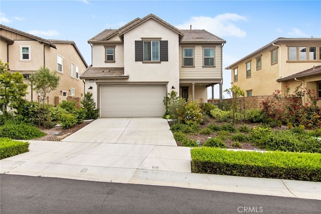 traditional-style house with an attached garage, stucco siding, driveway, and fence