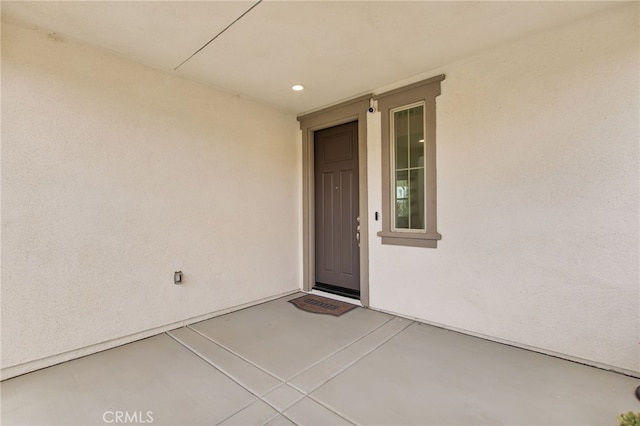 property entrance with stucco siding