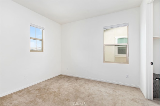 unfurnished room with baseboards and carpet