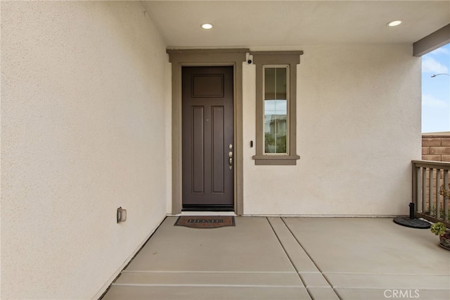 entrance to property with stucco siding