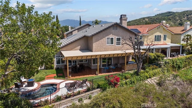24239 Bella Ct, Newhall, CA 91321 - rear view of house featuring stucco siding, a fenced backyard, a mountain view, a patio, and a chimney