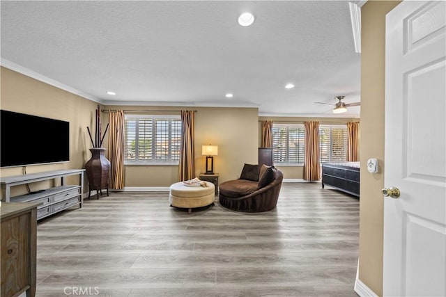 24239 Bella Ct, Newhall, CA 91321 - living room featuring crown molding, plenty of natural light, a textured ceiling, wood finished floors, and recessed lighting