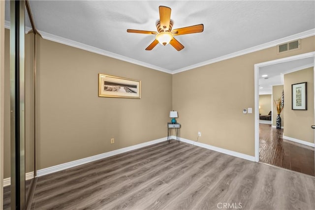 24239 Bella Ct, Newhall, CA 91321 - spare room featuring wood finished floors, ornamental molding, ceiling fan, and baseboards