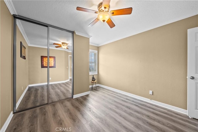 24239 Bella Ct, Newhall, CA 91321 - unfurnished bedroom featuring wood finished floors, ornamental molding, a closet, baseboards, and ceiling fan