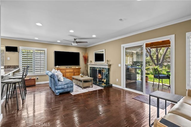 24239 Bella Ct, Newhall, CA 91321 - living room featuring crown molding, ceiling fan, a premium fireplace, recessed lighting, and dark wood-type flooring