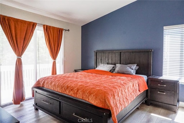 bedroom with light wood-type flooring and multiple windows