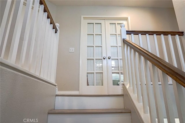 stairs featuring french doors