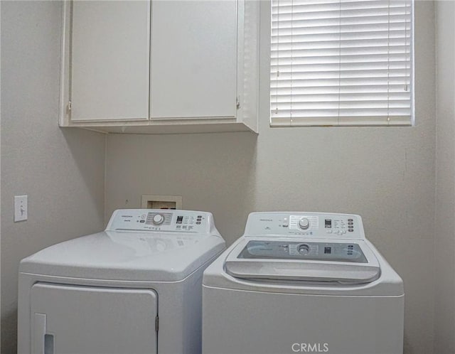 laundry room featuring cabinet space and washer and clothes dryer