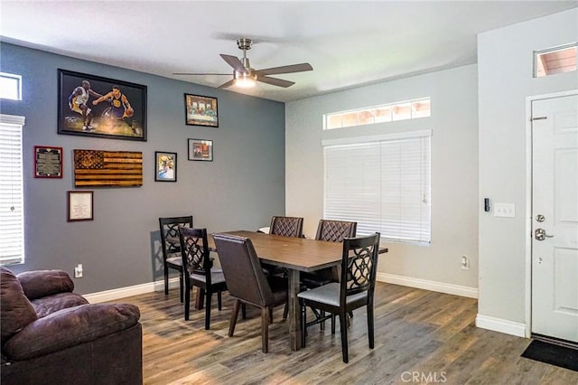 dining area with baseboards, plenty of natural light, ceiling fan, and wood finished floors