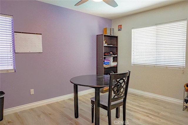 dining area featuring baseboards, ceiling fan, and light wood-style flooring