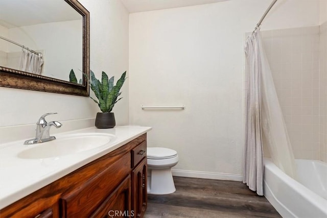 bathroom featuring shower / bath combo, wood finished floors, vanity, baseboards, and toilet