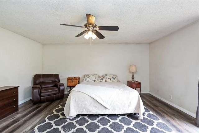 bedroom with baseboards, ceiling fan, and wood finished floors