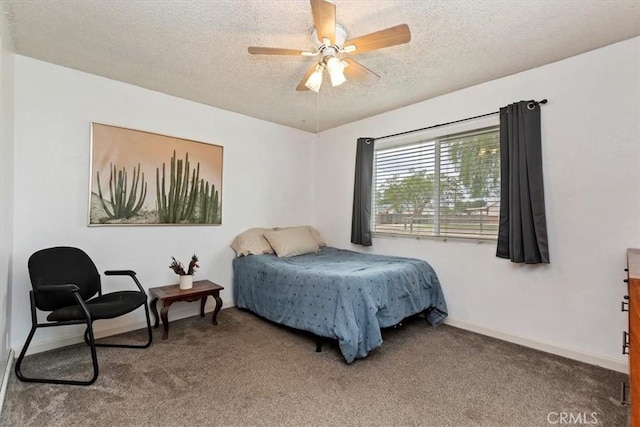 carpeted bedroom featuring baseboards, a textured ceiling, and ceiling fan