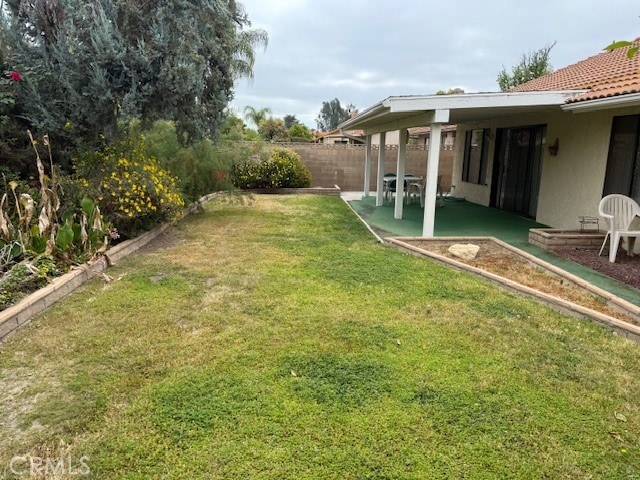 view of yard with a patio and fence