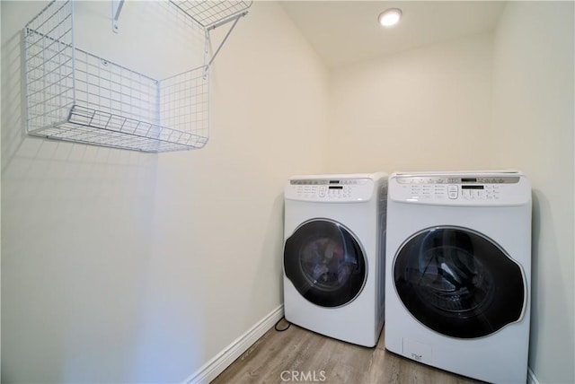624 Cedar Ave, Long Beach, CA 90802 - laundry room with separate washer and dryer and wood finished floors