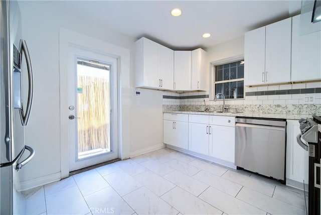 624 Cedar Ave, Long Beach, CA 90802 - kitchen with stainless steel appliances, white cabinetry, light stone counters, decorative backsplash, and recessed lighting