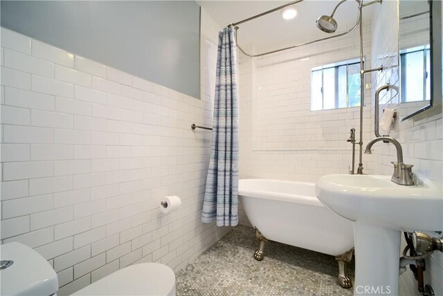 624 Cedar Ave, Long Beach, CA 90802 - full bathroom with tile walls and shower / bathtub combination with curtain