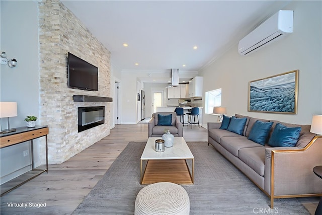 624 Cedar Ave, Long Beach, CA 90802 - living room featuring a wall mounted air conditioner, light wood-type flooring, crown molding, a fireplace, and recessed lighting