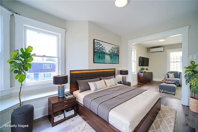 624 Cedar Ave, Long Beach, CA 90802 - bedroom with a wall unit AC and wood finished floors