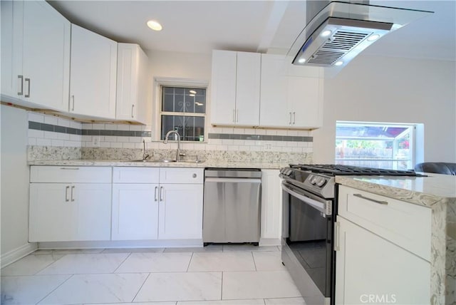 624 Cedar Ave, Long Beach, CA 90802 - kitchen with appliances with stainless steel finishes, extractor fan, white cabinetry, tasteful backsplash, and recessed lighting