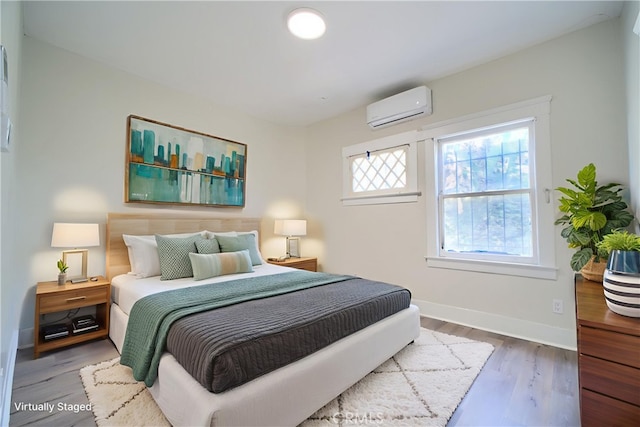 624 Cedar Ave, Long Beach, CA 90802 - bedroom featuring an AC wall unit and wood finished floors