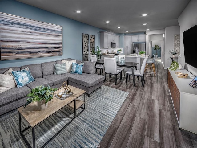 living area with recessed lighting and dark wood-style floors