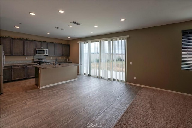 kitchen featuring appliances with stainless steel finishes, baseboards, recessed lighting, and visible vents