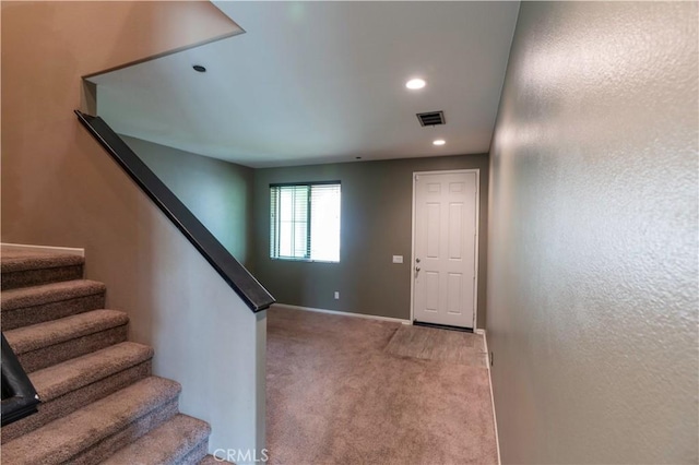 staircase featuring baseboards, carpet, recessed lighting, and visible vents