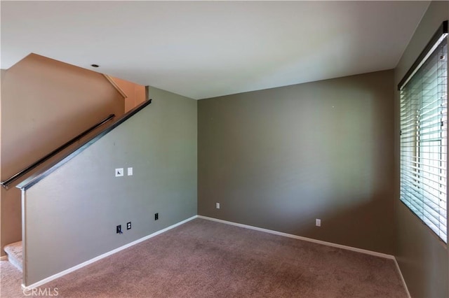 interior space featuring stairway, carpet floors, plenty of natural light, and baseboards