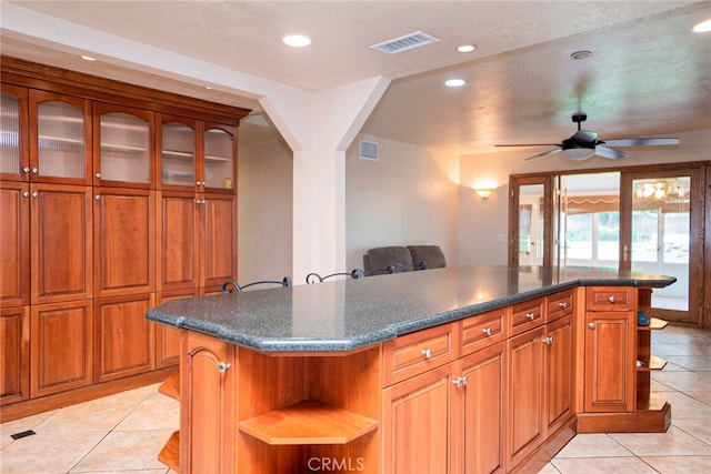 2136 Forbes Ave, Claremont, CA 91711 - kitchen featuring light tile patterned floors, dark countertops, open shelves, and visible vents