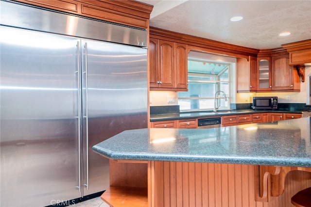 2136 Forbes Ave, Claremont, CA 91711 - kitchen featuring brown cabinetry, glass insert cabinets, recessed lighting, a sink, and stainless steel appliances