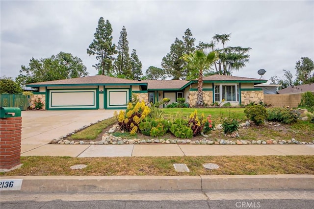2136 Forbes Ave, Claremont, CA 91711 - view of front of property with a garage, fence, a front lawn, concrete driveway, and stone siding
