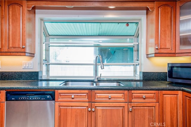 2136 Forbes Ave, Claremont, CA 91711 - kitchen with brown cabinets, a sink, glass insert cabinets, dark stone counters, and stainless steel appliances