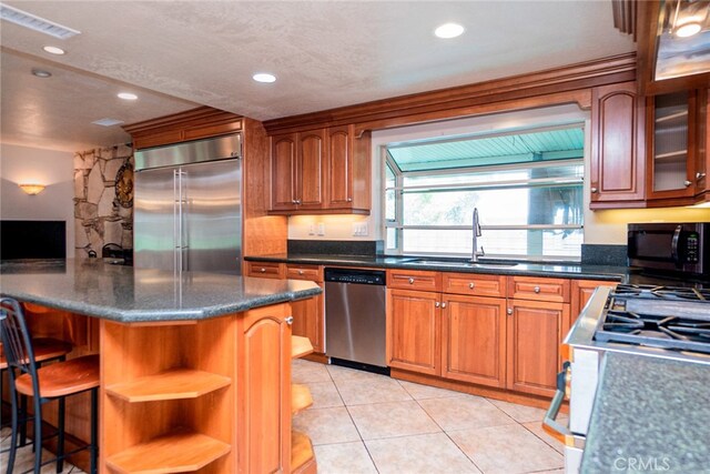 2136 Forbes Ave, Claremont, CA 91711 - kitchen featuring visible vents, light tile patterned flooring, brown cabinets, a sink, and stainless steel appliances
