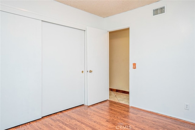 2136 Forbes Ave, Claremont, CA 91711 - unfurnished bedroom featuring visible vents, light wood-style flooring, and a closet