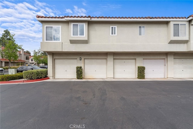 112 Cinnamon Teal, Aliso Viejo, CA 92656 - view of front of property with stucco siding, a tile roof, and an attached garage