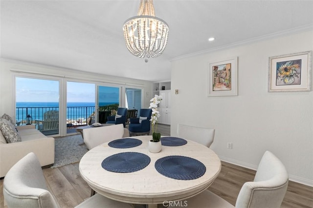 24242 Santa Clara Ave Unit 26, Dana Point, CA 92629 - dining room with ornamental molding, wood finished floors, baseboards, a water view, and a chandelier