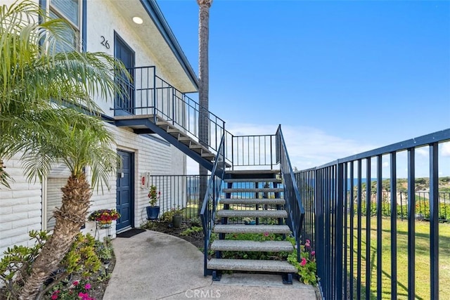 24242 Santa Clara Ave Unit 26, Dana Point, CA 92629 - view of property exterior featuring fence, stairs, and a lawn