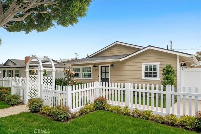 ranch-style house with fence private yard and a front lawn