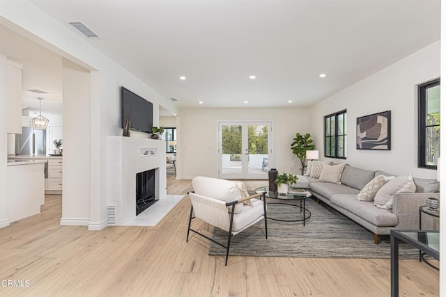 313 N Sunnyside Ave, Sierra Madre, CA 91024 - living room featuring recessed lighting, visible vents, a fireplace with flush hearth, and light wood-type flooring