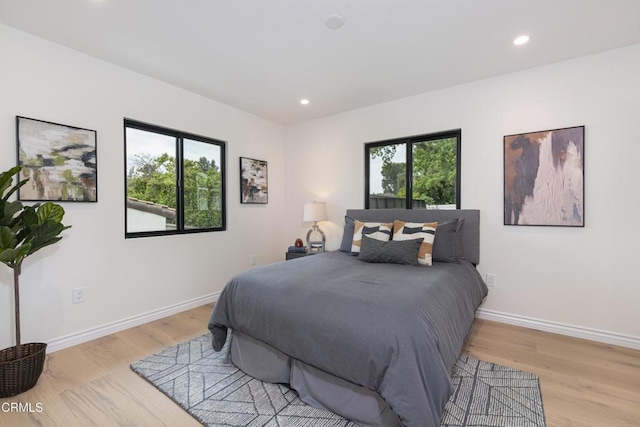 313 N Sunnyside Ave, Sierra Madre, CA 91024 - bedroom with baseboards, multiple windows, and light wood-type flooring