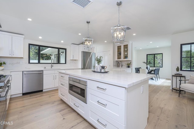 313 N Sunnyside Ave, Sierra Madre, CA 91024 - kitchen with visible vents, appliances with stainless steel finishes, a sink, a notable chandelier, and recessed lighting