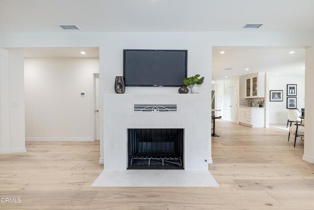 313 N Sunnyside Ave, Sierra Madre, CA 91024 - living room with recessed lighting, visible vents, a fireplace with flush hearth, and light wood-style floors