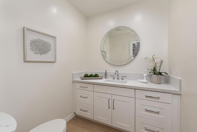 313 N Sunnyside Ave, Sierra Madre, CA 91024 - bathroom with vanity, baseboards, toilet, and wood finished floors