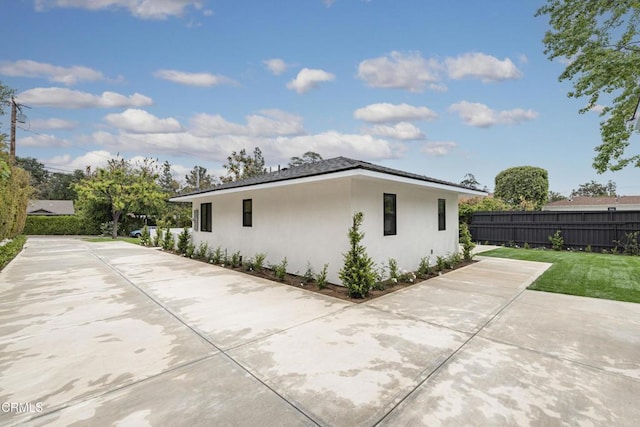 313 N Sunnyside Ave, Sierra Madre, CA 91024 - view of home's exterior featuring fence, a patio area, and stucco siding