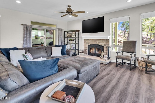 living room with recessed lighting, ceiling fan, wood finished floors, and a fireplace